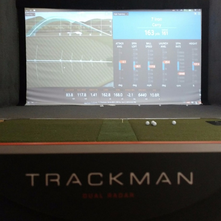 TrackMan hitting bay with a 7-iron launch on the screen